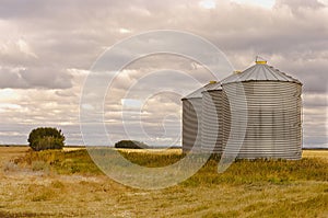 Grain silos sitting on a field