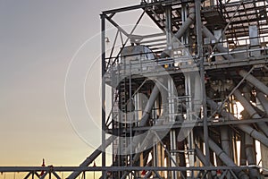 Grain storage constructions on sunset. Industrial background.