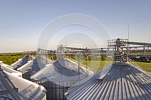 Grain storage tanks on sunset. Agricultural background.