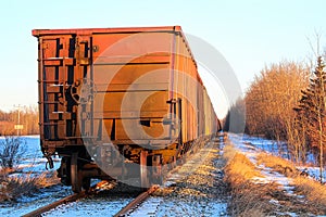 A grain train car waiting on a track