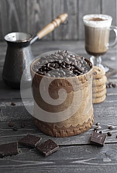 Grains of aromatic coffee in a vintage jar on a dark wooden background