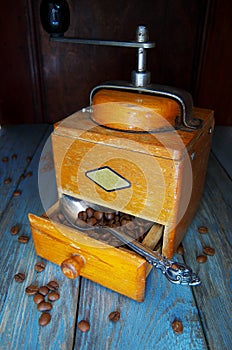 Grains of fresh fragrant coffee and an old vintage coffee grinder