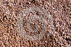 The grains of ground black coffee are very close. Close up groun