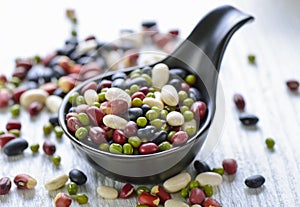 Grains mix beans on black spoon