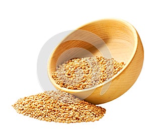 Grains organic wheats are scattered out of the wooden bowl