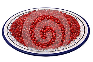 Grains of pomegranate on a traditional Tunisian plate, isolated