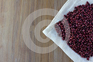 Grains red beans on sack on wooden table side