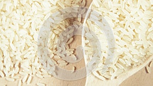 Grains in wooden spoons on wooden background top view