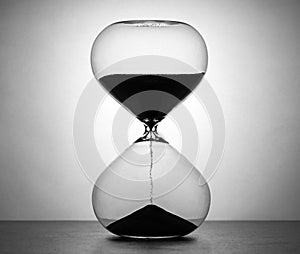 Grainy hourglass, isolated on white.