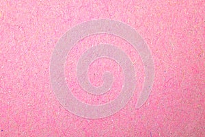Grainy pink paper texture, paper surface background close-up photo