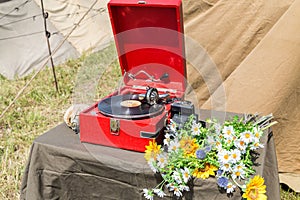 gramophone with a plate camera and flowers on the