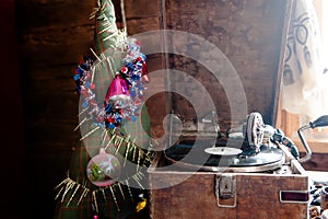 Gramophone playing a record. with vinyl on background decorations, cap, tree and bright lights