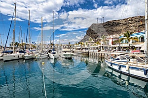 Gran Canaria, Spain - Feb 21, 2023: Colorful canarian fishing boats at the harbor in Puerto de Mogan, Gran Canaria,Spain