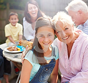 Gran and I. Portrait of a granddaughter and grandmother embracing one another at a family lunch - Copyspace.