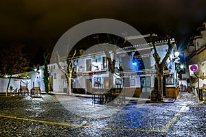 GRANADA, SPAIN, JANUARY 3, 2016: night view of a closed bar near to a lookout spot for the alhambra palace in granada