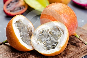 Granadilla or Grenadia Passionfruit Cut in Half Exotic Fruits on Wooden Board