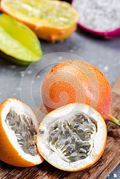 Granadilla or Grenadia Passionfruit Cut in Half Exotic Fruits on Wooden Board