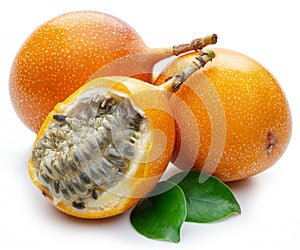 Granadilla with leaves and passion fruit half isolated on a white background