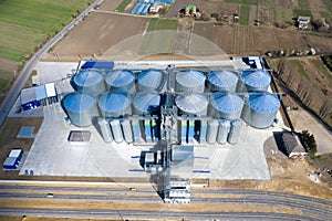 Granary elevator. Silver silos on agro-processing and manufacturing plant for processing drying cleaning