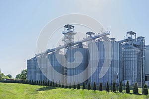 Granary. A large modern  agro-processing plant for the storage and processing of grain crops. Large metal barrels of grain.