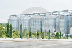 Granary. A large modern  agro-processing plant for the storage and processing of grain crops. Large metal barrels of grain.