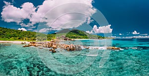 Grand Anse beach at La Digue island in Seychelles. Turquoise blue lagoon and exotic tropical island in background.