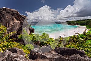 Grand Anse beach with Rainy clouds. La Digue island, Seychelles