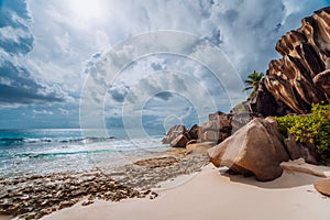 Grand anse, La Digue island, Seychelles. Granite boulders, ocean and cloudscape photo