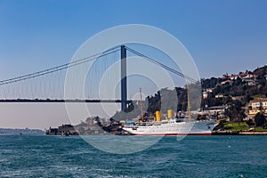 The grand bridge of Sultan Mehmed Fatih through the Bosphorus and the sea ship, Turkey