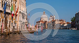 Grand Canal and Basilica Santa Maria della Salute, Venice, Italy. In the foreground is a traditional Venetian wharf with