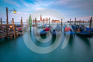 Grand canal with gondolas at peaceful sunset, Venice Lagoon, Italy