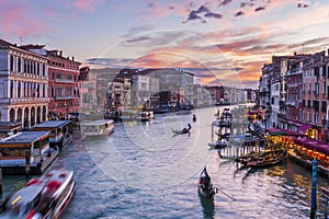 The Grand Canal and its gondoliers from the Rialto Bridge in the evening in Venice in Veneto, Italy