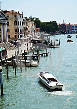 Grand Canal, poles, boats and architecture in Venice, in Europe