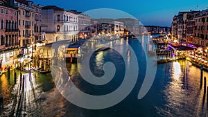 Grand Canal in Venice, Italy day to night timelapse. Gondolas and city lights from Rialto Bridge.