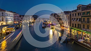 Grand Canal in Venice, Italy day to night timelapse. Gondolas and city lights from Rialto Bridge.