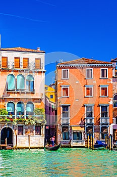 Grand Canal waterway in Venice historical city centre with gondolier on sailing gondola