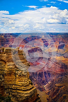 The Grand Canyon - Magnificent vertical view of Colorado River running through the depths with late afternoon sun highlighting the