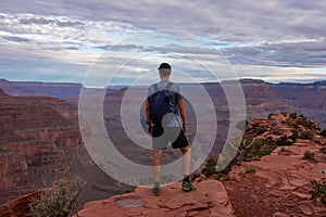 Grand Canyon - Man with panoramic aerial view from Ooh Ahh point on South Kaibab hiking trail at South Rim, Arizona, USA