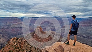 Grand Canyon - Man with panoramic aerial view from Ooh Ahh point on South Kaibab hiking trail at South Rim, Arizona, USA