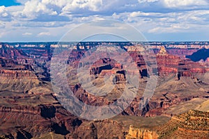 Grand canyon from South rim viewpoint. Brlliant colors of the northern wall; clouds overhead.