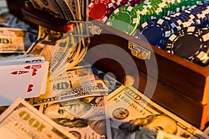 A grand casino super prize - a case full of chips, dollars and playing cards on a black background