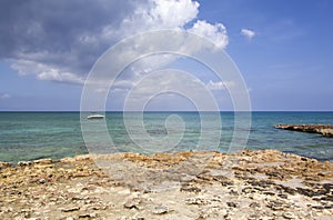 Grand Cayman Island Rocky Shore And A Boat