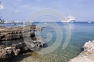 Grand Cayman Island Rocky Shore And A Cruise Ship
