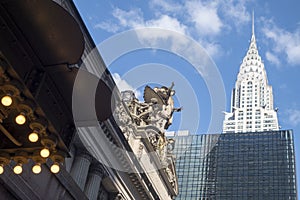 Grand central station entrance marquie looking up sculpture and sky and the Chrysler and other buldings at 42nd street new york,