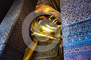 Grand Golden Reclining Buddha Statue in Main Hall of Wat Pho Phra Chetupon Vimolmangklararm Temple, Landmark of Bangkok, Thailand