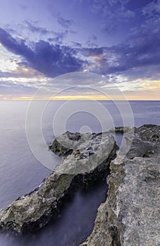 Grand majestic rocks on the shore silky ocean