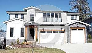 Grand Modern Luxury Real Estate Home House Maison White Siding Exterior Garage Blue Sunny Sky Background