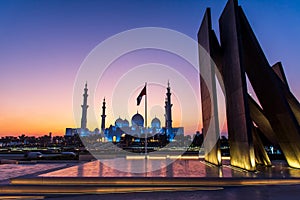 Grand Mosque in Abu Dhabi and Wahat al Karama monument after sunset