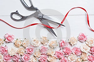 Grand opening concept with scissors cutting red ribbon on white