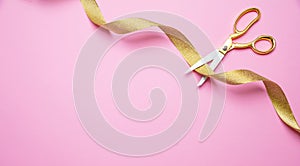 Grand opening. Gold scissors cutting golden ribbon, pink background, copy space, top view